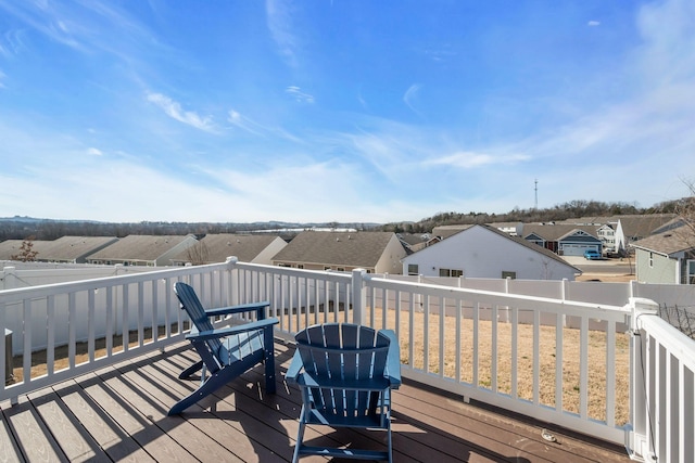 wooden deck with a residential view and a fenced backyard