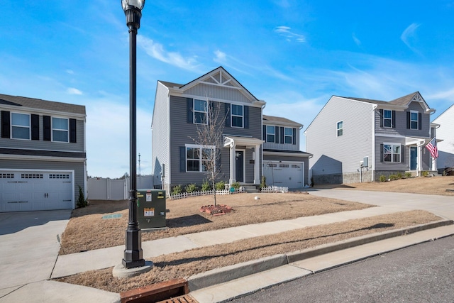 view of front of home with a garage, driveway, and fence