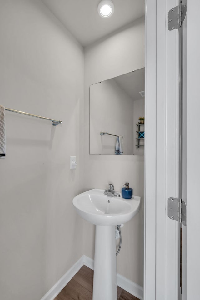 bathroom with baseboards and wood finished floors