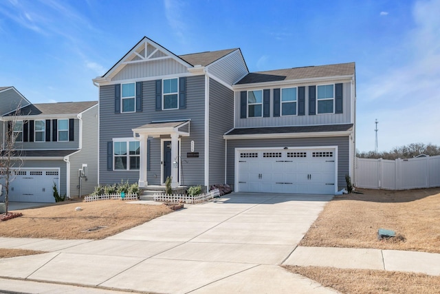 view of front of house featuring board and batten siding, fence, driveway, and a garage