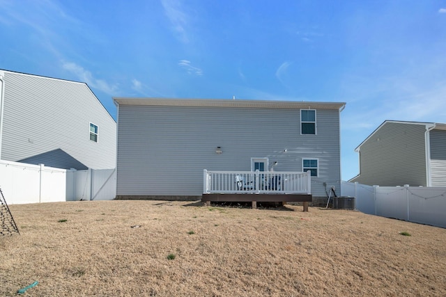 back of property with cooling unit, a fenced backyard, a lawn, and a deck