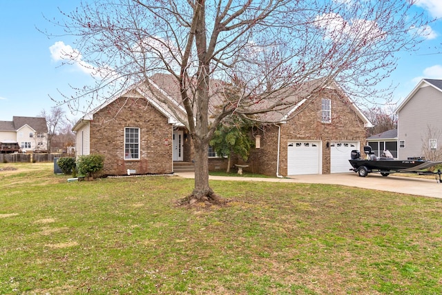 view of front of property with a garage, a front yard, concrete driveway, and brick siding