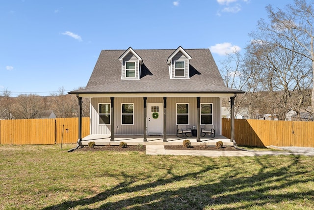 cape cod-style house featuring covered porch, fence, a front lawn, and a gate