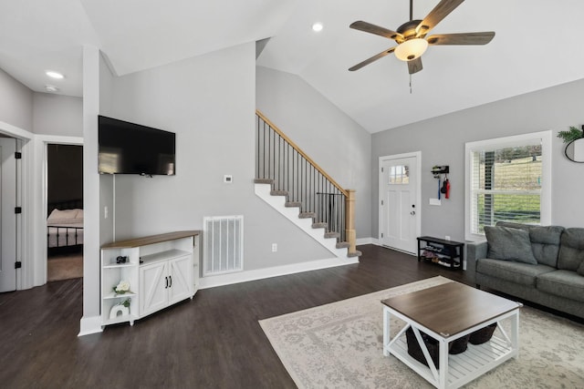living area featuring visible vents, baseboards, stairway, lofted ceiling, and wood finished floors