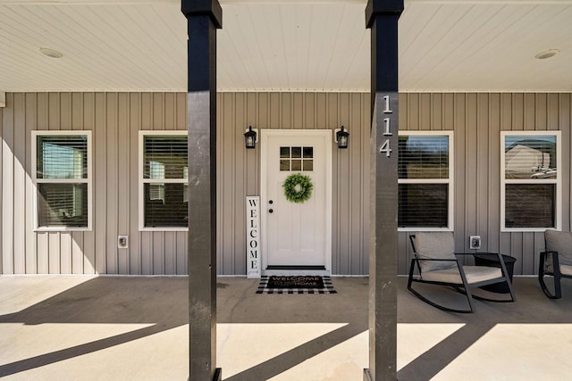 view of exterior entry with board and batten siding