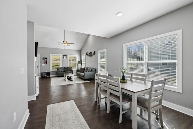 dining area with dark wood finished floors, baseboards, lofted ceiling, and a ceiling fan