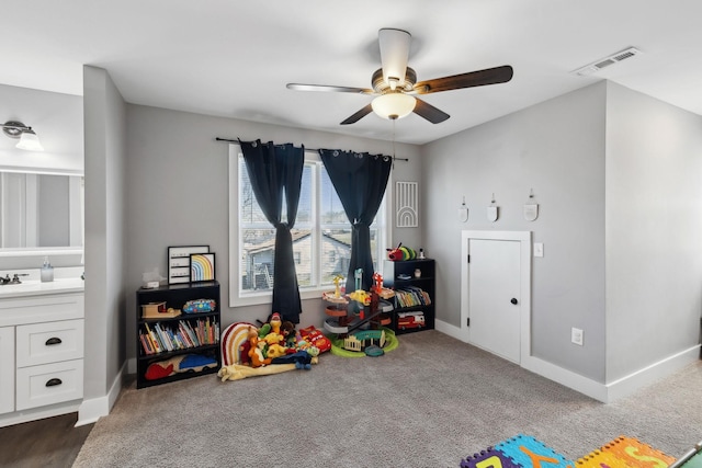 rec room featuring baseboards, visible vents, and dark carpet