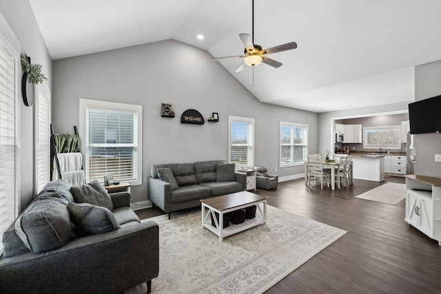 living area featuring baseboards, recessed lighting, dark wood-style floors, high vaulted ceiling, and a ceiling fan