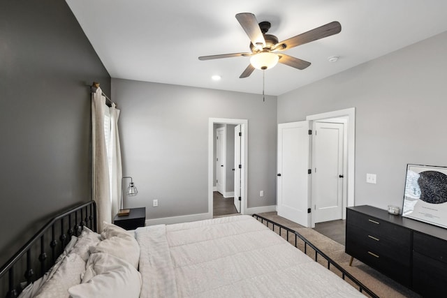 bedroom with a ceiling fan, carpet, and baseboards