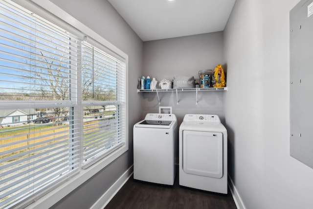 laundry room with washing machine and clothes dryer, laundry area, dark wood-type flooring, and baseboards