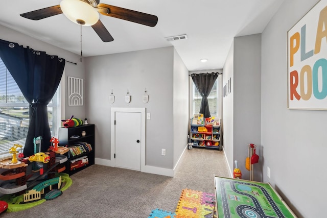 playroom with visible vents, baseboards, carpet, and a ceiling fan