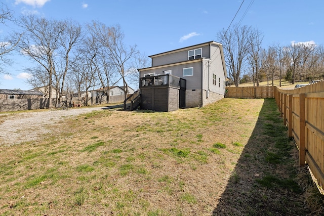 back of property with stairway, a yard, a fenced backyard, and a wooden deck