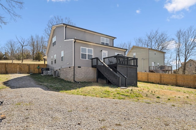 back of house featuring stairway, fence, gravel driveway, a deck, and central air condition unit