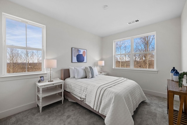 bedroom with baseboards, visible vents, and carpet flooring