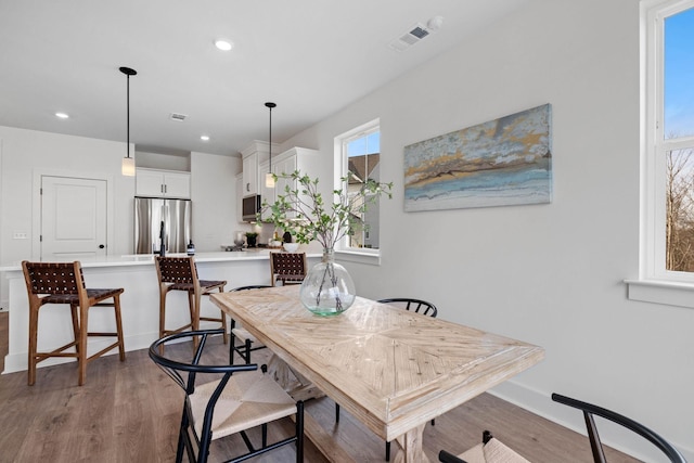 dining room featuring recessed lighting, visible vents, and light wood-style flooring