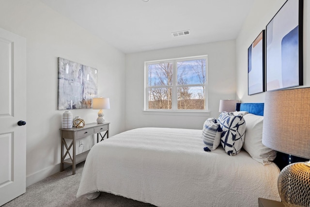 carpeted bedroom with visible vents and baseboards