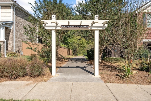 view of home's community featuring fence and a pergola