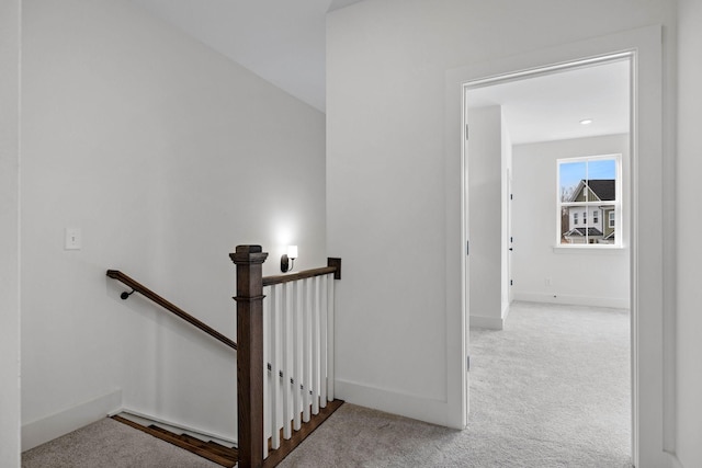 staircase featuring carpet floors and baseboards