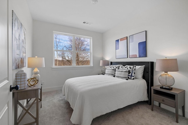 carpeted bedroom featuring visible vents and baseboards