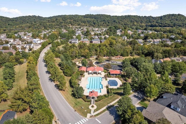 drone / aerial view featuring a residential view and a view of trees