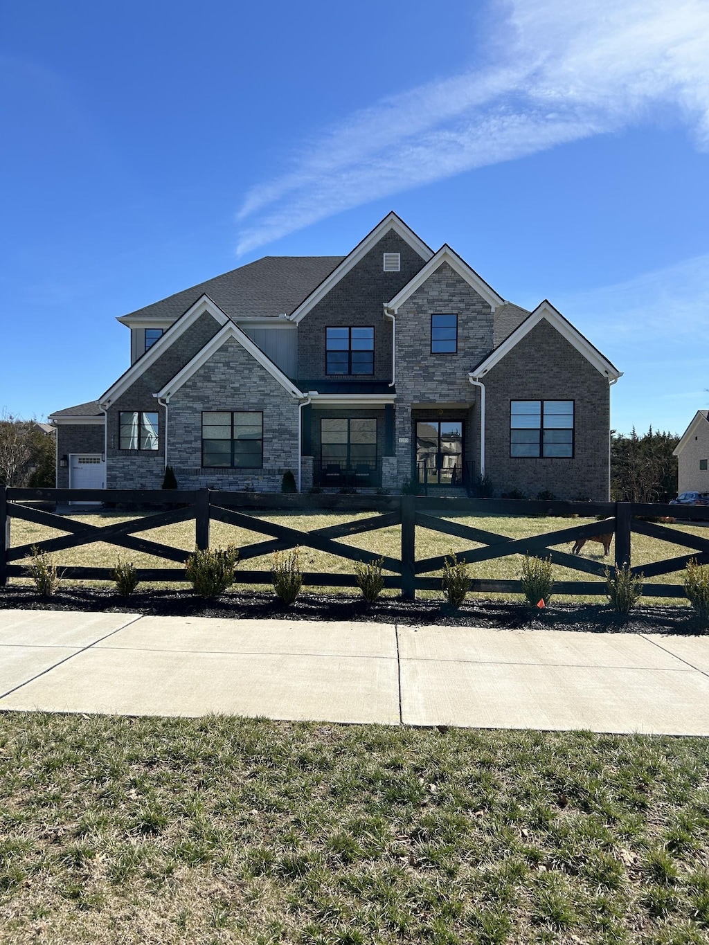 view of front facade featuring stone siding and a front yard