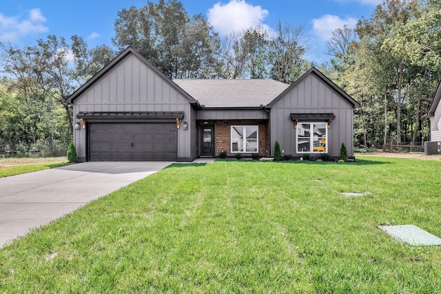 modern inspired farmhouse featuring concrete driveway, board and batten siding, an attached garage, and a front yard