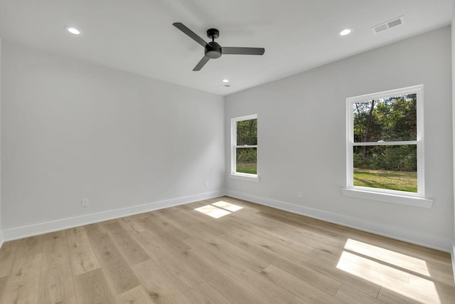 spare room with light wood finished floors, recessed lighting, visible vents, ceiling fan, and baseboards