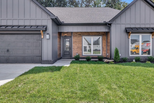 entrance to property with board and batten siding, a yard, a shingled roof, and a garage