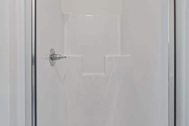 interior details featuring a shower