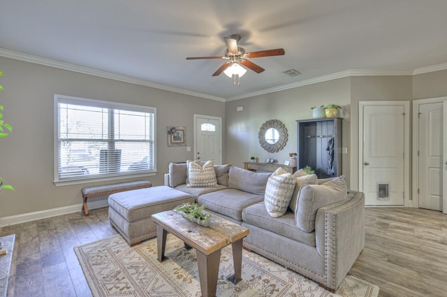 living room with light wood-style floors, a ceiling fan, visible vents, and ornamental molding