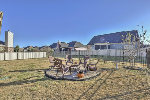view of yard with a fenced backyard, an outdoor fire pit, and a patio