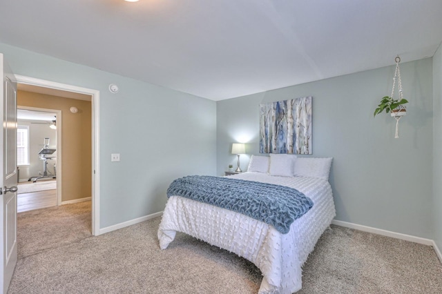bedroom featuring baseboards and carpet