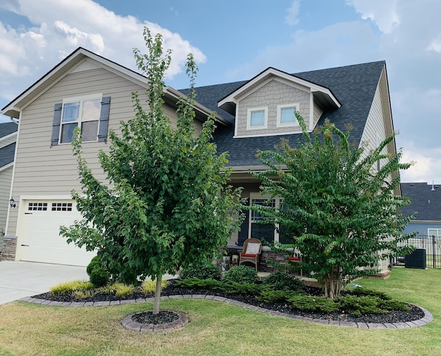 view of front of home with driveway, a shingled roof, a front lawn, and central AC