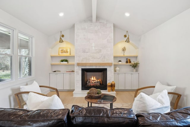 living room featuring light wood-style floors, recessed lighting, a fireplace, and vaulted ceiling with beams