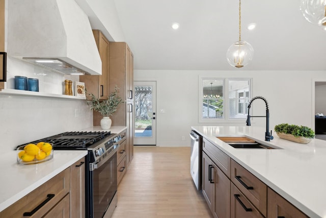 kitchen featuring custom range hood, stainless steel appliances, a sink, and light countertops