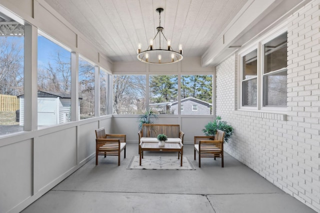 sunroom featuring wooden ceiling and a chandelier