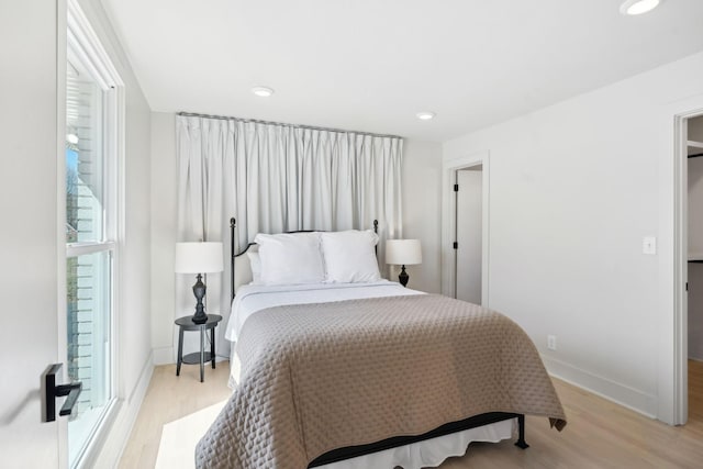 bedroom featuring light wood-style floors, recessed lighting, and baseboards