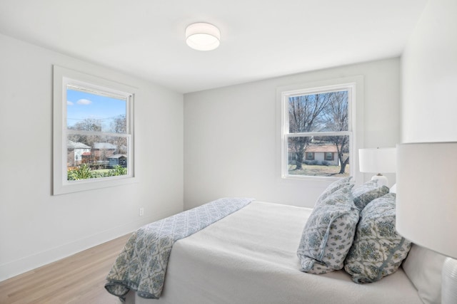 bedroom featuring wood finished floors and baseboards