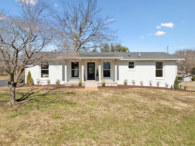 ranch-style home with brick siding and a front yard