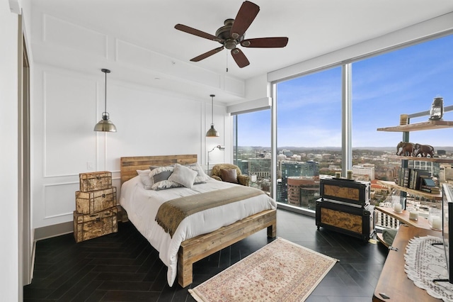 bedroom featuring expansive windows and a ceiling fan