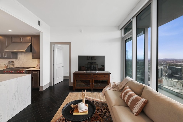 living room with recessed lighting, visible vents, and baseboards