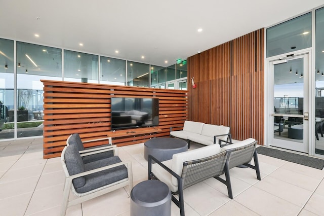 tiled living area featuring expansive windows, plenty of natural light, and recessed lighting