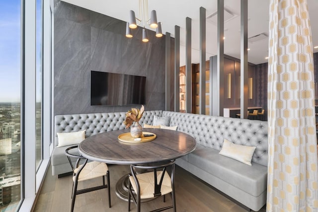 dining area featuring breakfast area and wood finished floors