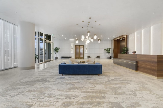 living area with a chandelier, expansive windows, and recessed lighting