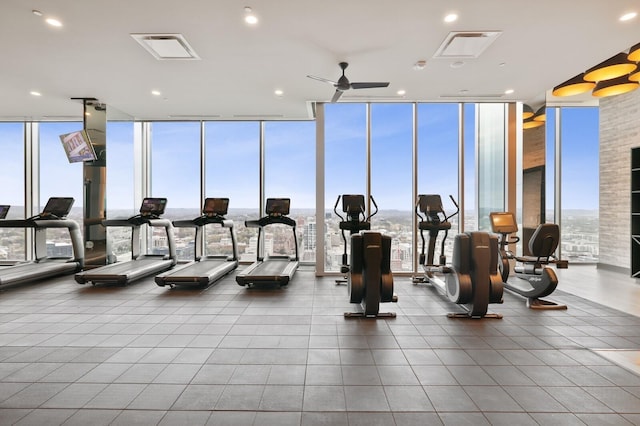 gym with expansive windows, ceiling fan, and recessed lighting