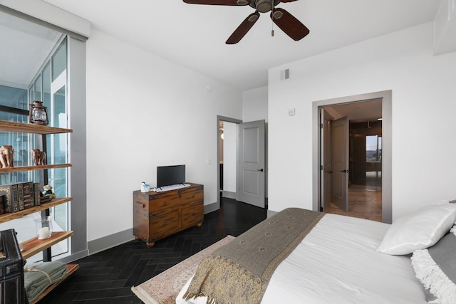 bedroom featuring a ceiling fan, floor to ceiling windows, visible vents, and baseboards