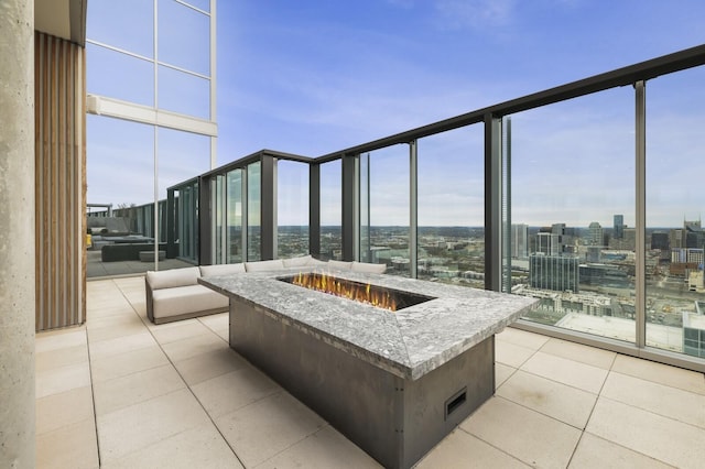 view of patio / terrace featuring a view of city and an outdoor fire pit