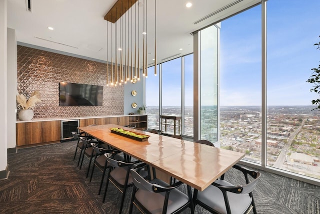 dining area with beverage cooler, expansive windows, visible vents, and recessed lighting