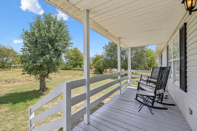 wooden deck with a porch and a yard