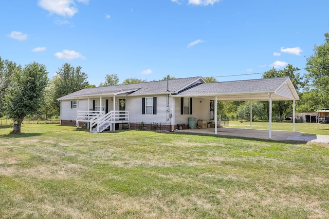 rear view of property with a carport, crawl space, driveway, and a lawn